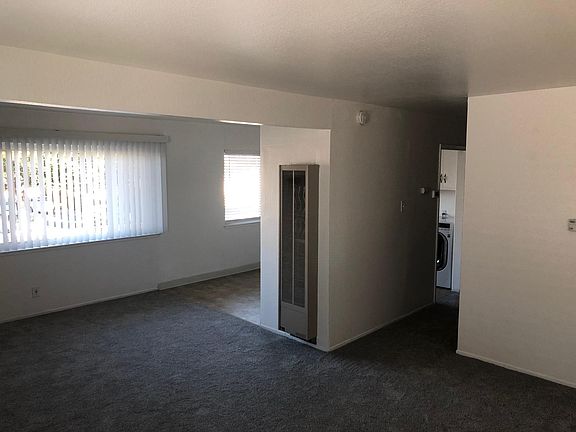 View from living area of dining area kitchen and beginning of hallway.