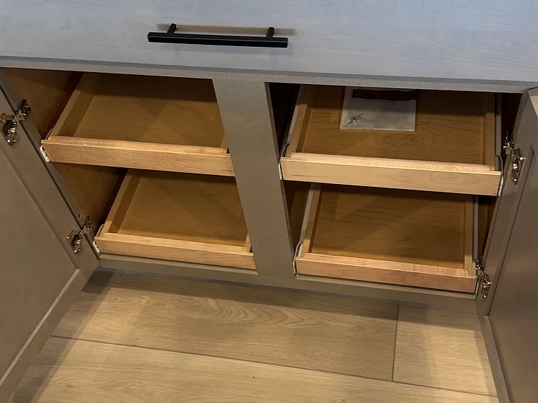 Underneath pots and pan drawer.