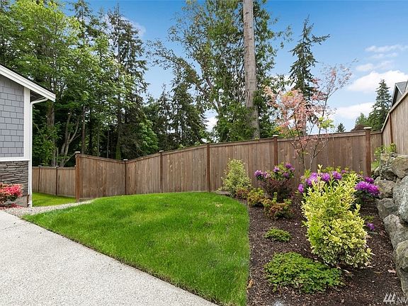 The low maintenance front yard opens onto a fully fenced yard.  These yards have seasonal views of the Puget Sound and the entrance to Eagle Harbor!