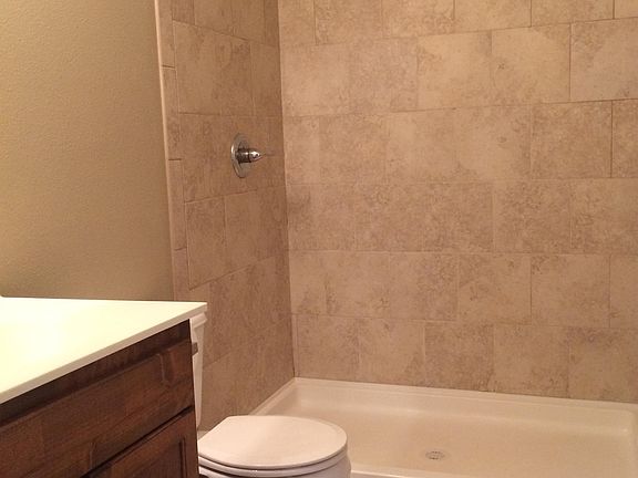 Master bathroom with tile shower and low maintenance.
