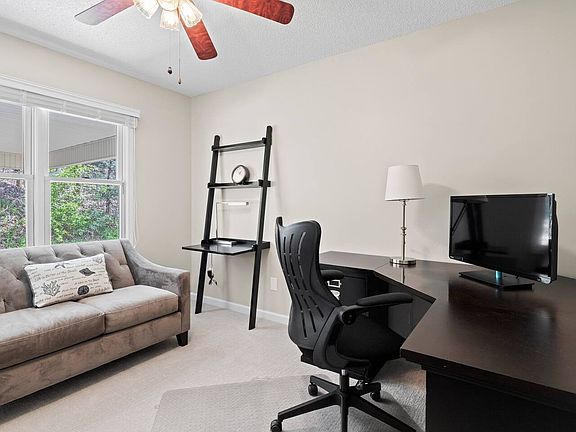 Separate office with desk, monitor, and printer
