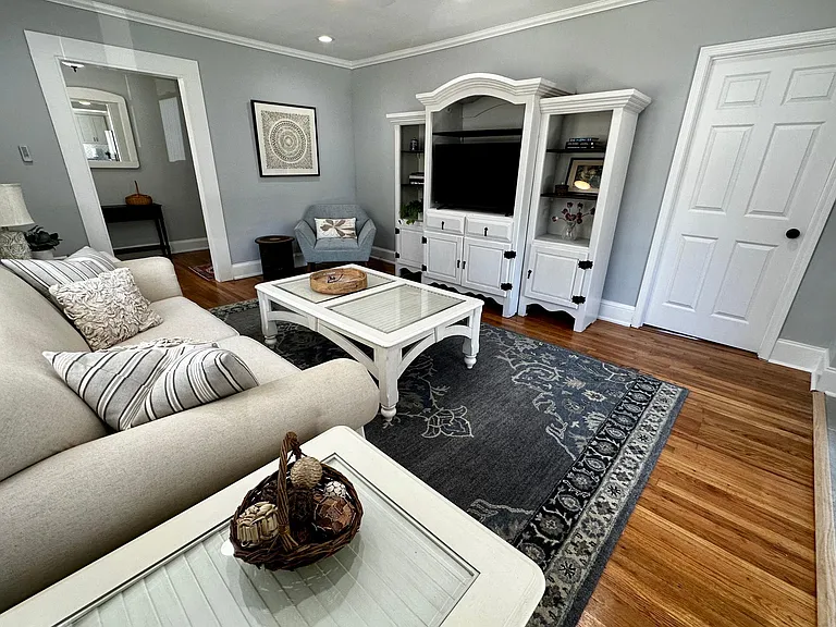 Living room showing master suite entrance door