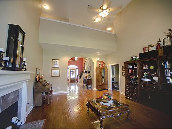 Living Room or Great Room : Another view of the high ceilings, fireplace, large gathering room!