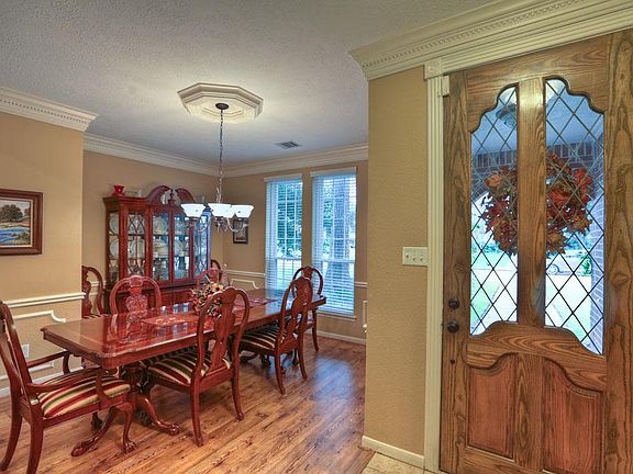 Leaded glass entry door with beautiful trim. Crown molding and chair rail with designed paint in the