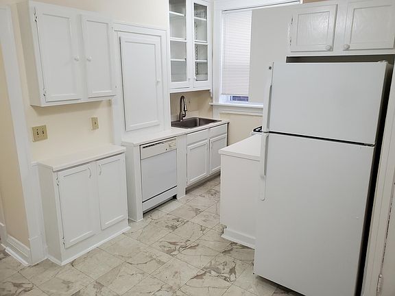 One side of the kitchen with new double wide sink, glass cabinet, lots of other cabinet space, new stove, dishwasher