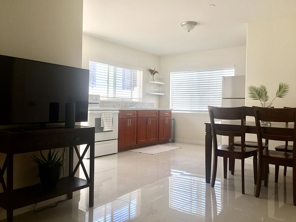 Open kitchen, dining, and living room space. Picture is furnished, but the unit is UNFURNISHED