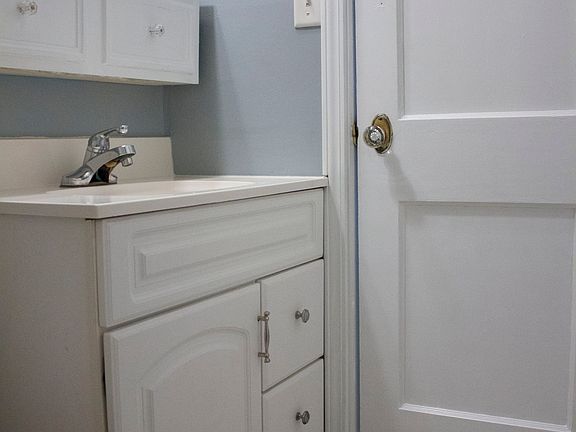 The bathroom features upper and lower vanity storage as well