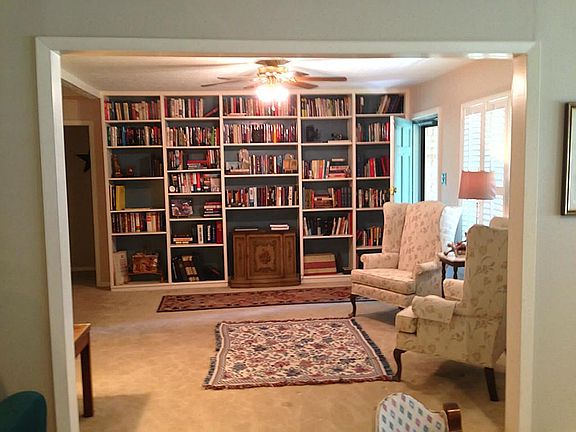 View of front door showing wall built in bookcases