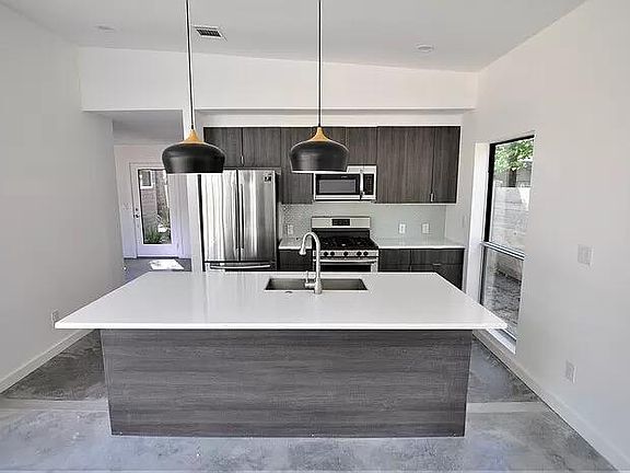 Modern kitchen with stainless appliances.