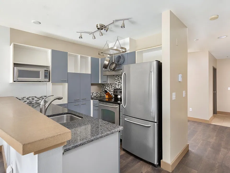 Kitchen with pot rack. Tons of cabinets.