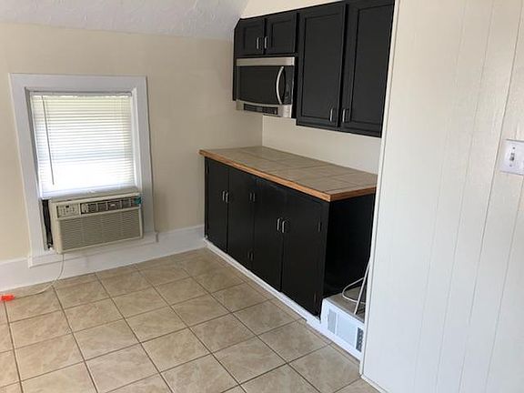 Kitchen, AC unit stays with apartment