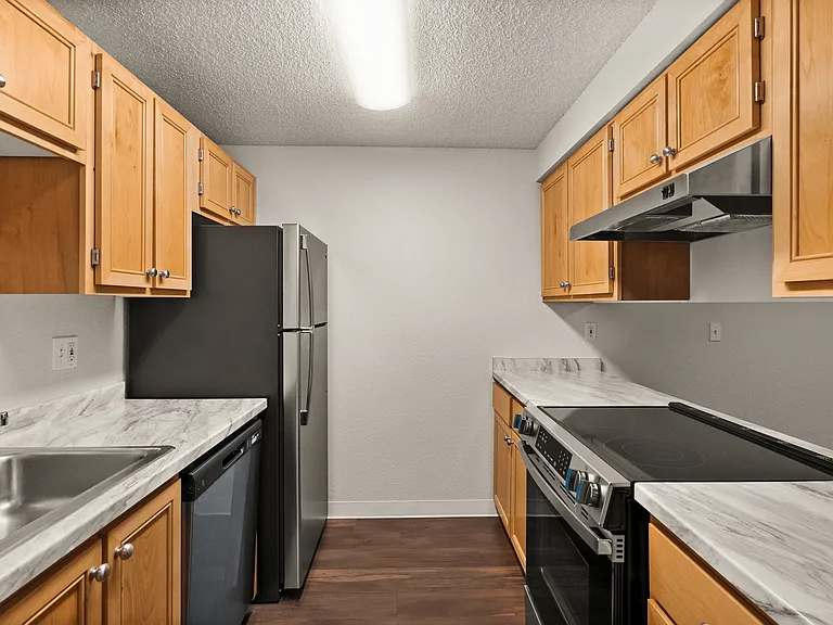 Modern kitchen with sleek stainless steel appliances, elegant wood cabinetry, and marble countertops. Modern kitchen with sleek stainless steel appliances, elegant wood cabinetry, and marble countertops.
