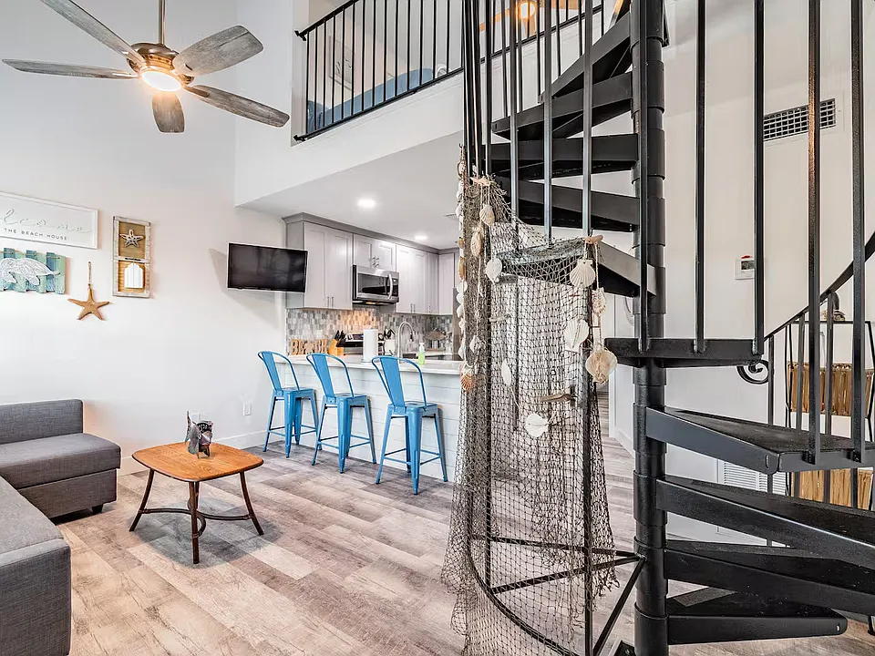 As you enter front door you walk into the living room & open concept kitchen space with peninsula seating. A spiral staircase that leads to the second loft bedroom upstairs!