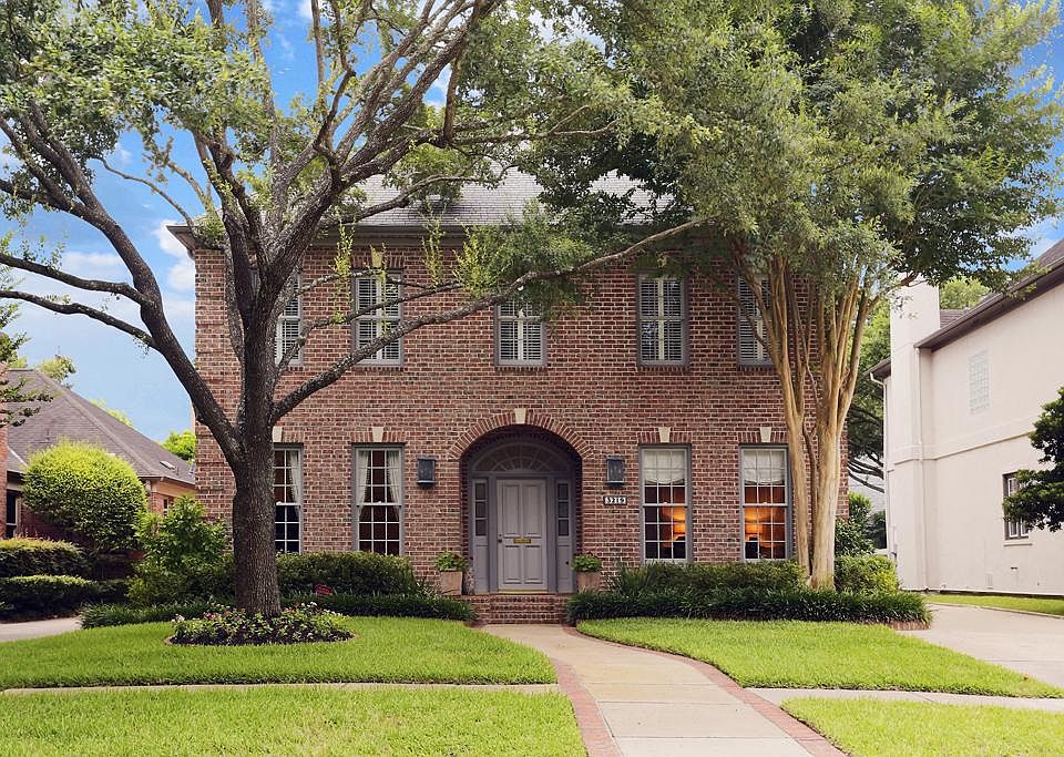 Picture perfect two-story brick custom home with study, two-room guest quarters, workshop and 3 car 
