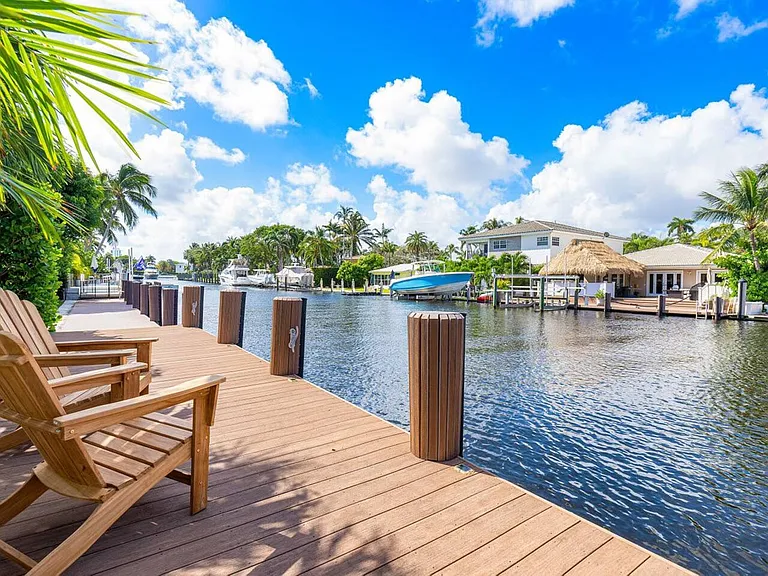 Private waterfront dock with cozy seating and stunning canal views.