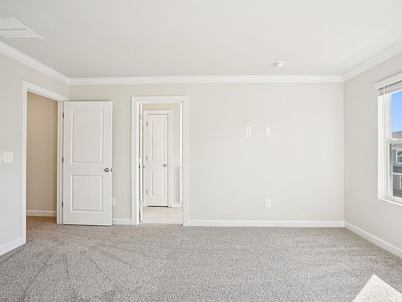 The primary bedroom connects conveniently to a private ensuite.