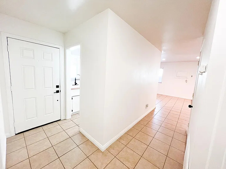 Hallway with coat closet on right of photo