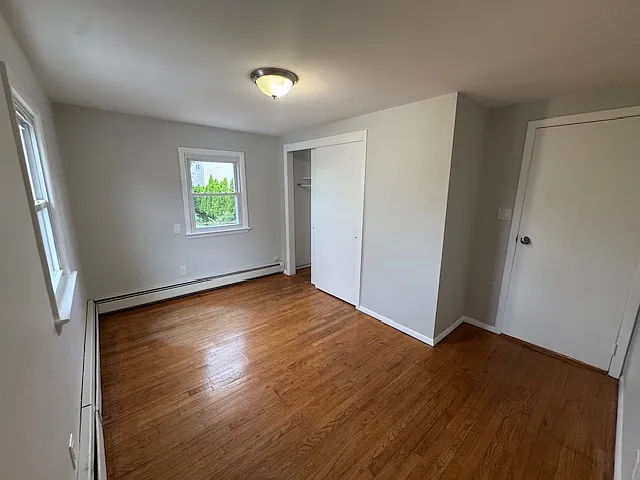 Bedroom 2: features natural lighting, hardwood floors and closet