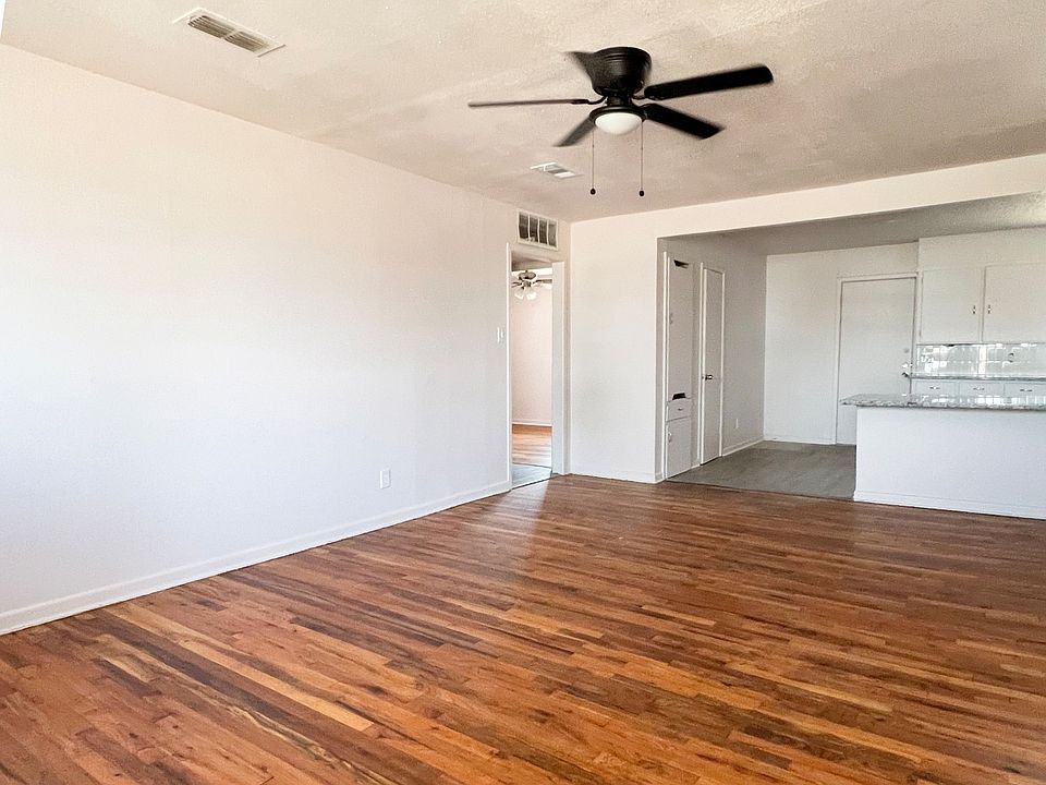 Freshly redone hardwood floors and a kitchen with updated tile, a peninsula for counter seating