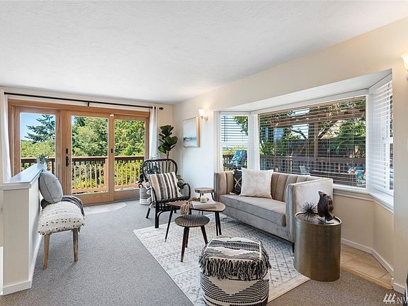 High-quality Andersen sliding French patio door provides floor-to-ceiling territorial views and opens the living room to the deck.