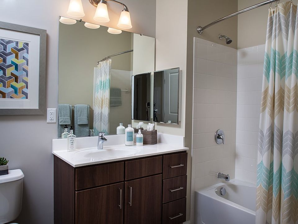 Classic Bath with chocolate pecan cabinetry, white laminate countertops, and hard surface flooring