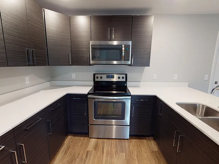 The Hickory floor plan features a large kitchen with ample cabinetry, quartz counters, and stainless steel appliances. The Hickory floor plan features a large kitchen with ample cabinetry, quartz counters, and stainless steel appliances.