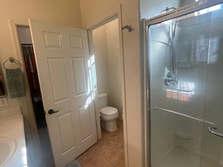 Master bathroom looking into toilet room and shower