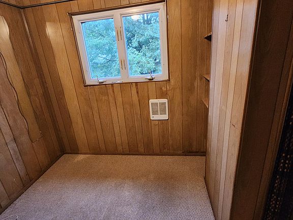 office or storage with a closet and shelves,