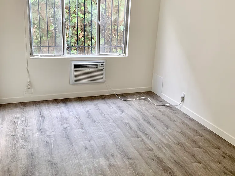 bedroom with wall air conditioner unit