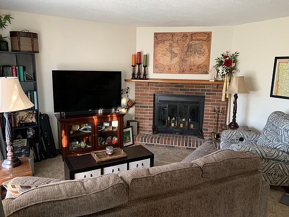 Main level living area with wood burning fireplace