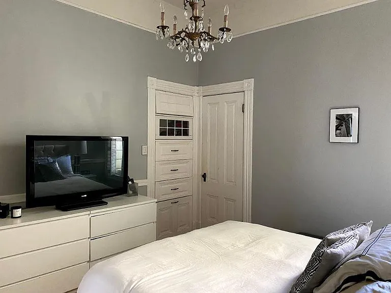 Master bedroom with original Victorian built-in drawers. All chandeliers original with home.