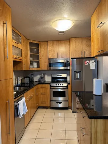 Kitchen includes dishwasher, refrigerator, oven, microwave, coffee maker, and ample pantry space. Fully stocked with plates, bowls, cups, utensils, and cookware.