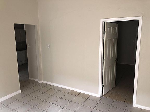 Extra living space next to entrance of house can be used as a study or formal living room. Door enters into fourth bedroom located in front of the house.
