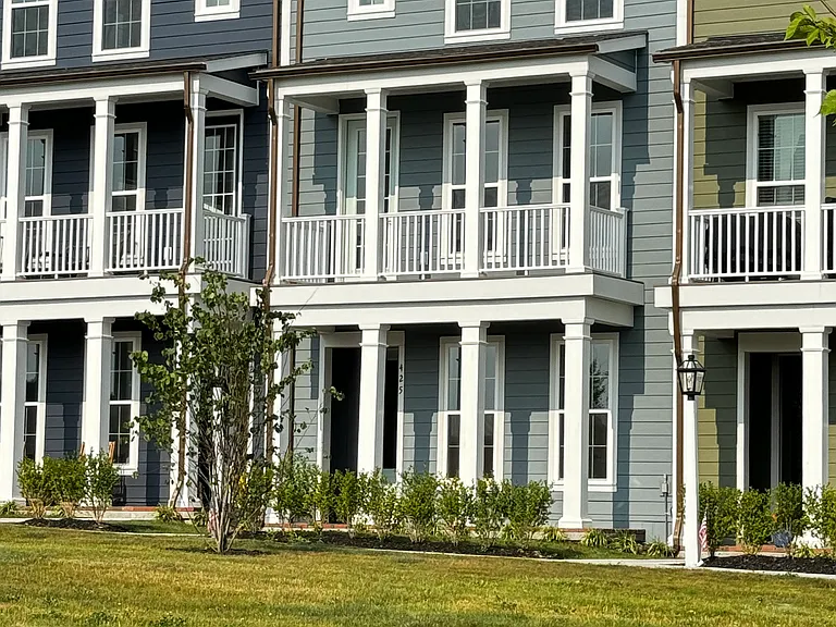Three story light blue townhome