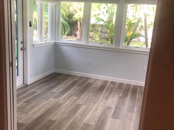 Sunroom has oversized impact resistant casement widows all around for a full back yard view