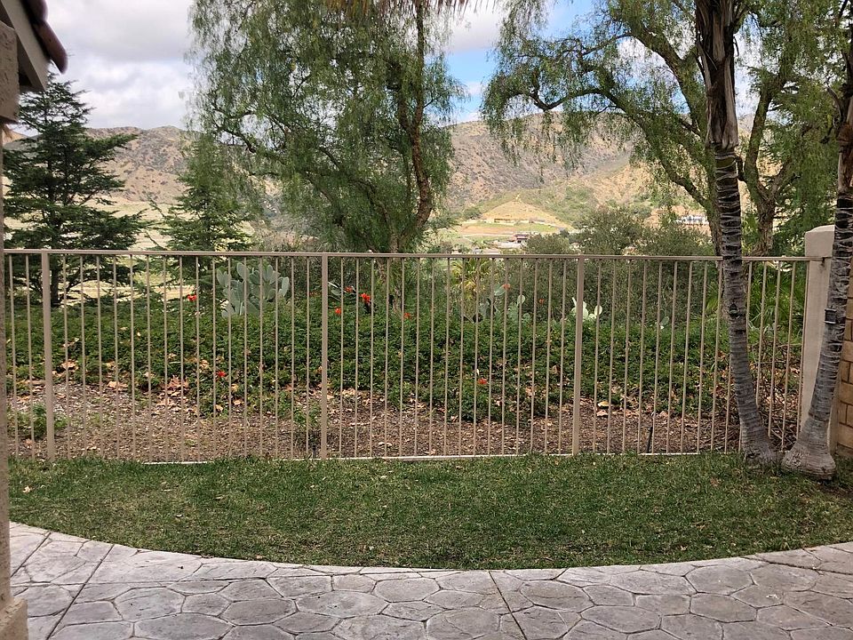 View of the canyon and horses grazing on the hill.