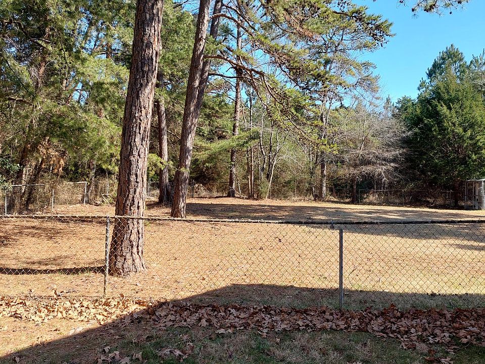 This is view of the back yard from the left of the house. The entire back yard is enclosed with a fence. Storage building in back yard