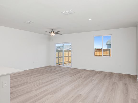 The family room is spacious with a ceiling fan,