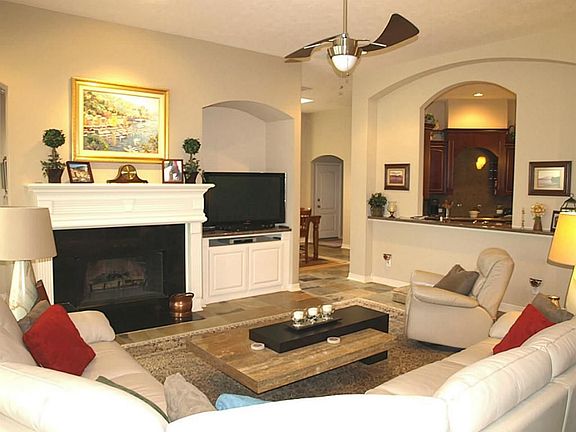 Spacious living area, opens to kitchen with breakfast bar.