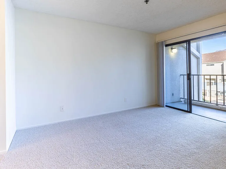Carpeted Bedroom with Balcony
