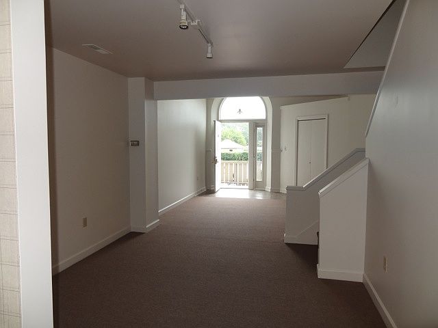 View from kitchen through living room to front door.