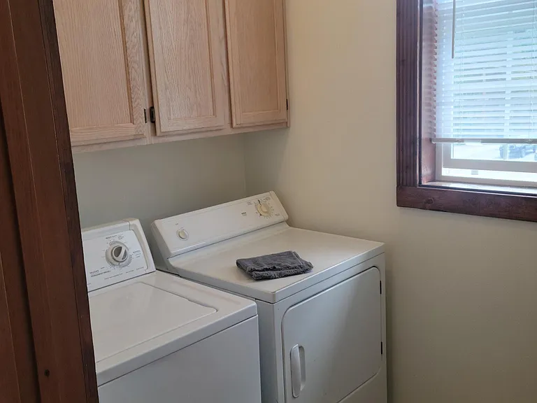 Handy laundry room off the kitchen adds convenience to the apartment.