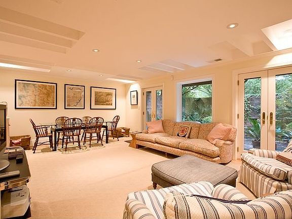 FRENCH DOORS AND WINDOWS OPEN TO A BEAUTIFUL WALLED PATIO