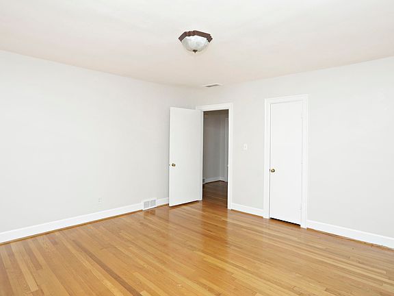 The open door is in the bedroom and it leads into the foyer. The foyer has a coat closet and leads in to the bathroom & then the living room.