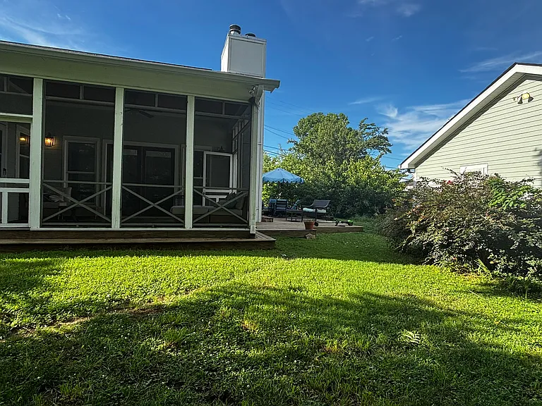 Screened-in porch with double doors off master bedroom.