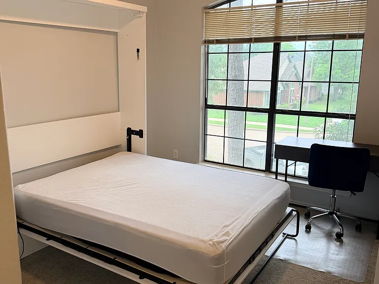 Murphy bed in room unfolds to a queen bed, bedding available