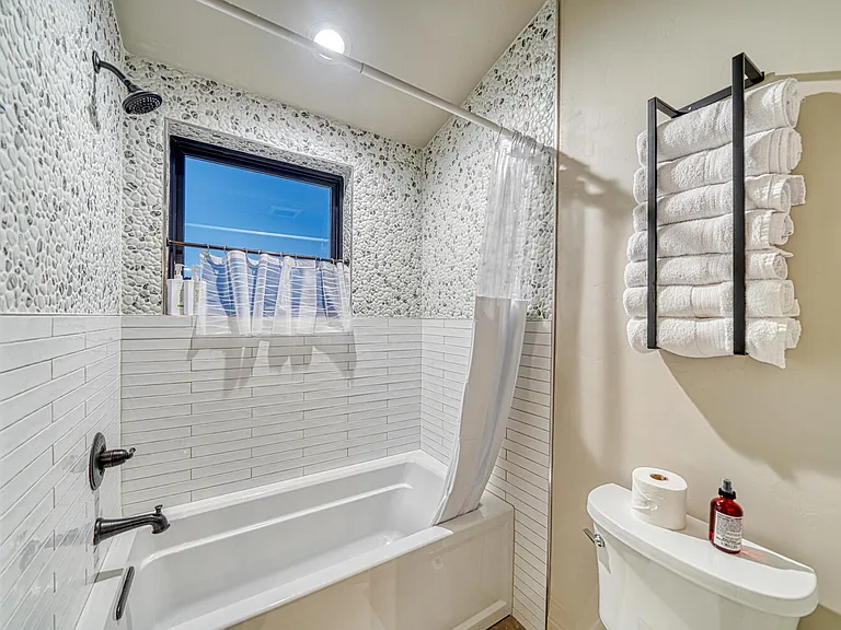 Shower and toilet area for the Chalk Cliff/Bear Cub Suites offers a tub shower combo and still a great view.