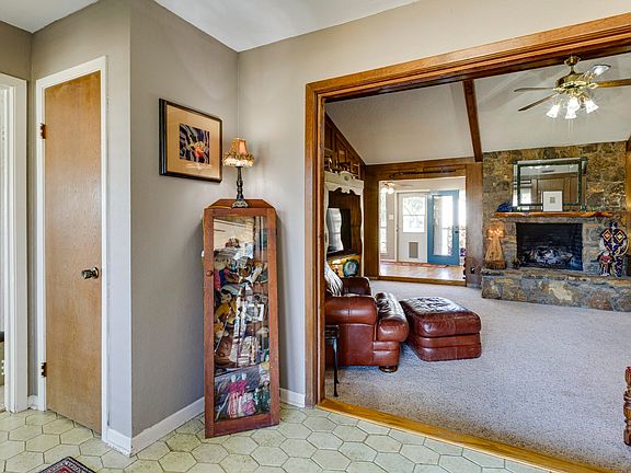 As you enter the home, you are greeted by the beatuful stone fireplace and custom wooden mantel.