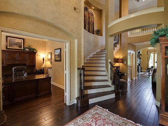 Elegant two story foyer with spiral staircase circling the beautiful rotunda.
