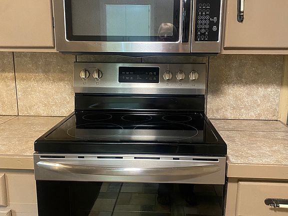 A new glass top stove has regular and convection oven and over-the-stove microwave